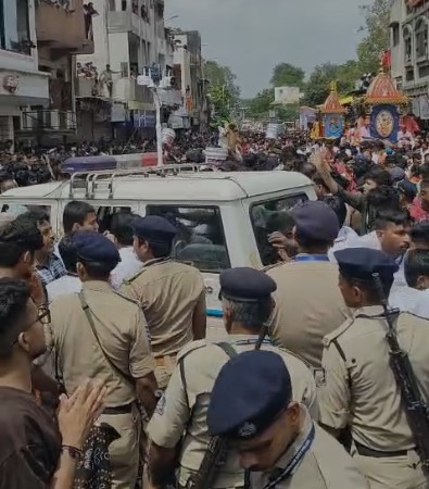 Police vehicle stalled, people help the cops push the vehicle