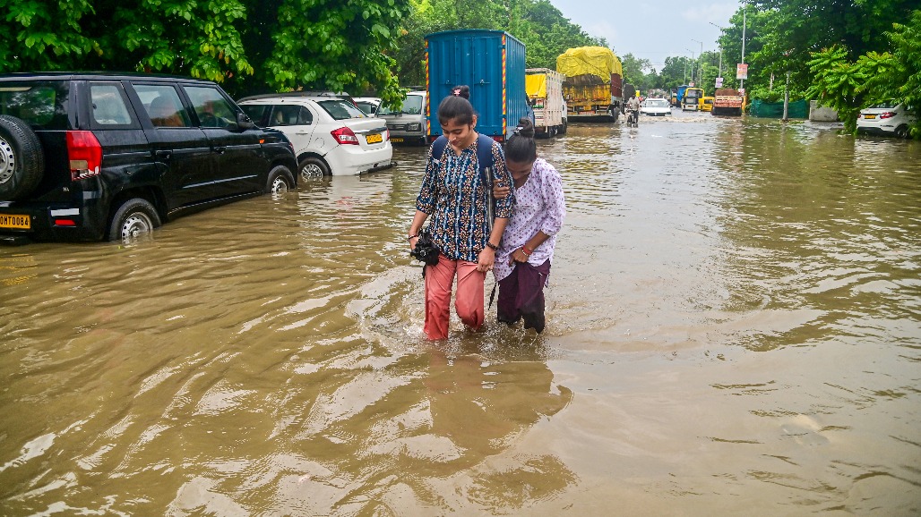 9-Uttar Pradesh-Prayagraj--- Girls wade through a waterlogged road after heavy rain in Prayagraj, Uttar Pradesh,.jpg