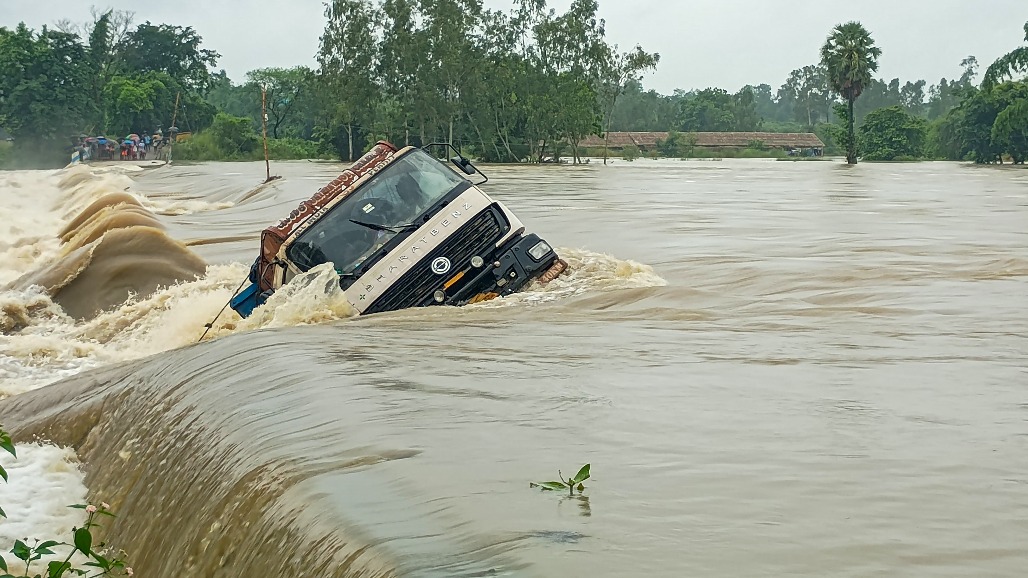 1-West Bengal-Bankura--- A dumper lorry gets stuck on a bridge after the water of the Gandeshwari river spills over the bridge at Mankanali, in Bankura district, West Bengal,.jpg