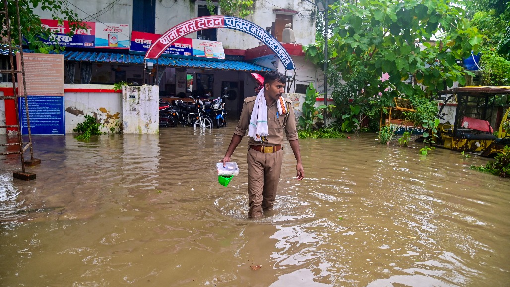 11-Uttar Pradesh-Prayagraj--- A policeman wades through waterlogged surroundings outside a police station after heavy rain, with floodwater inundating the premises, in Prayagraj, Uttar Pradesh,.jpg