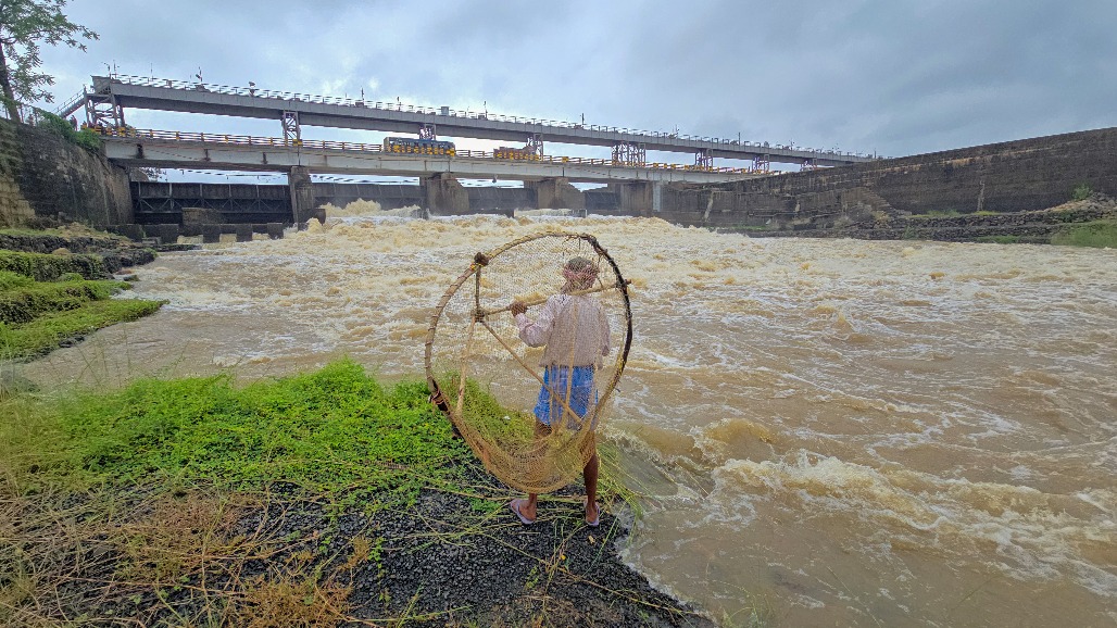 6-West Bengal-Suri--- A person prepares a fishing net to cast into the Tilpara Barrage to catch aquatic animals as the water level in the Mayurakshi River rises in Suri, Birbhum district of West Bengal,.jpg